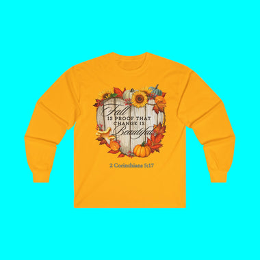 White long-sleeve tee shirt with autumn-themed design says "Fall is Proof that Change is Beautiful"