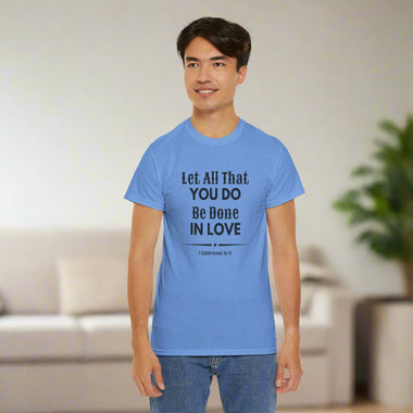 Person wearing a gray t-shirt with 1 Corinthians 16:14 on front