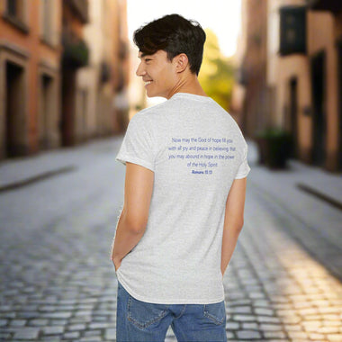 Person wearing a gray t-shirt with Romans 15:13 text on the back