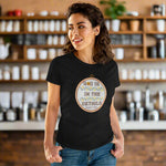 Woman wearing a black t-shirt with a motivational quote on a beige background