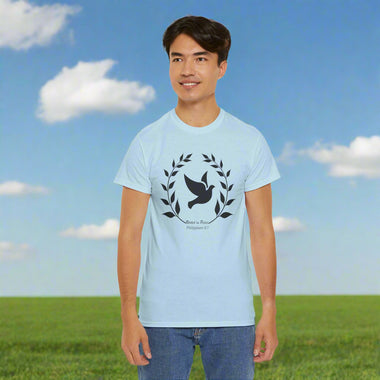 Person wearing a gray t-shirt with a black frond of leaves and dove