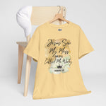 Yellow t-shirt with Jesus Saw My Mess and Still Called Me Worthy text and graphic on a wooden chair against a white background