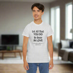 Person wearing a gray t-shirt with 1 Corinthians 16:14 on front
