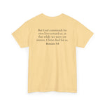 Yellow t-shirt with black text of Romans 5:8 on a white background