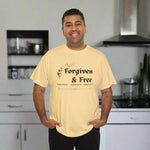 Man wearing a yellow t-shirt with 'Forgiven & Free' text kitchen background